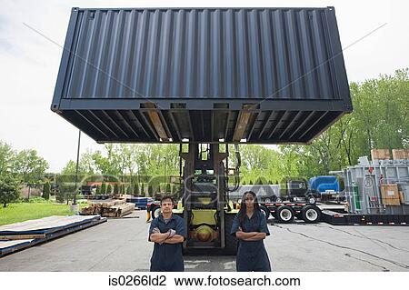 Stock Image - Colleagues by forklift truck. Fotosearch