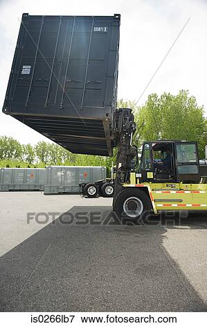 Forklift truck lifting cargo container View Large Photo Image Stock Photo - Forklift truck lifting cargo container. Fotosearch