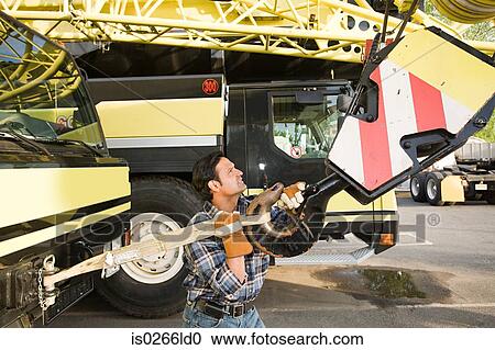 Man with crane truck View Large Photo Image Stock Image - Man with crane truck. Fotosearch