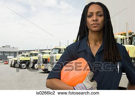 Stock Image - Worker by trucks. Fotosearch