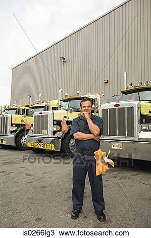 Worker by trucks View Large Photo Image Stock Image - Worker by trucks. Fotosearch