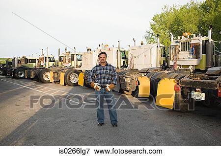 Stock Photo - Worker by trucks. Fotosearch
