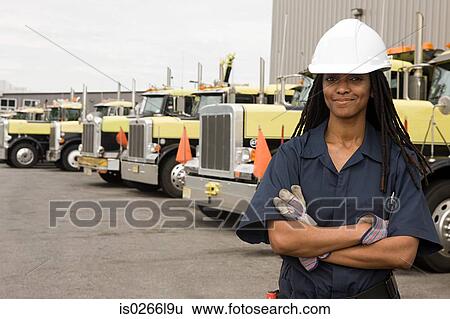 Stock Photograph - Worker by trucks. Fotosearch