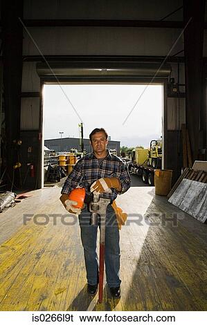 Stock Photograph - Worker in warehouse. Fotosearch