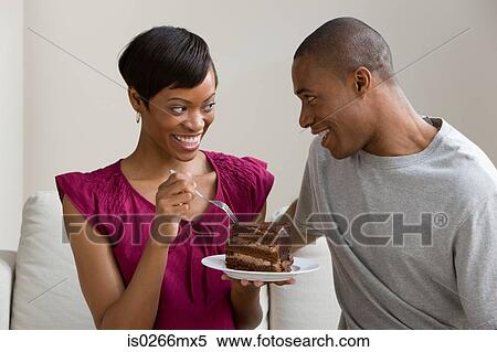 A couple sharing a cake View Large Photo Image Stock Photography - A couple sharing a cake . Fotosearch