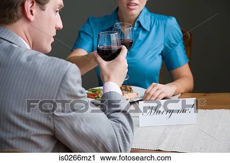 A man and woman toasting View Large Photo Image Stock Image - A man and woman toasting. Fotosearch