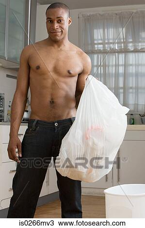 A man emptying a bin View Large Photo Image Stock Image - A man emptying a bin. Fotosearch