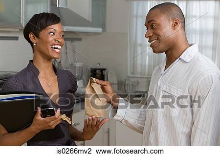 A man handing a woman lunch View Large Photo Image Stock Image - A man handing a woman lunch. Fotosearch