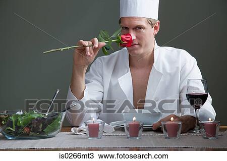 A man in chefs outfit smelling a rose and a romantic meal View Large Photo Image Stock Image - A man in chefs outfit smelling a rose and a romantic meal. Fotosearch