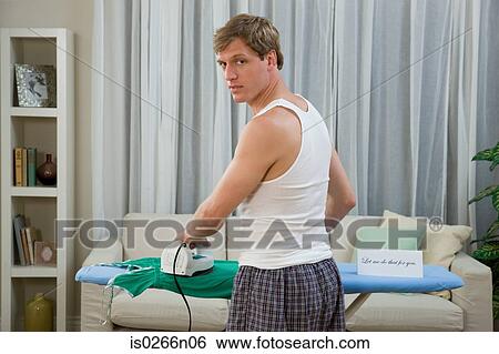 A man ironing View Large Photo Image Stock Photograph - A man ironing. Fotosearch