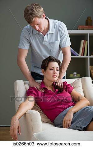 A man massaging a womans shoulders View Large Photo Image Stock Image - A man massaging a womans shoulders. Fotosearch