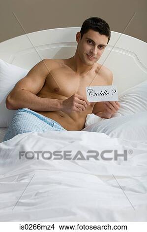 A man reclining on a bed View Large Photo Image Picture - A man reclining on a bed. Fotosearch