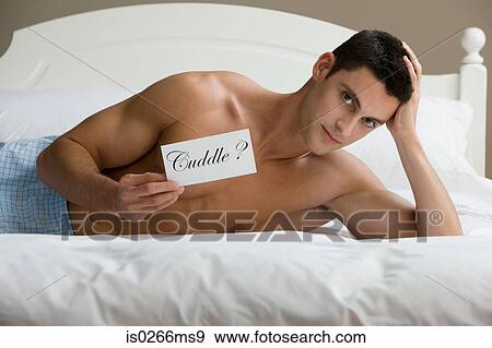 A man reclining on a bed View Large Photo Image Stock Photo - A man reclining on a bed. Fotosearch