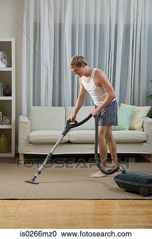 A man vacuum cleaning View Large Photo Image Stock Image - A man vacuum cleaning. Fotosearch