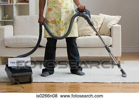 A man vacuum cleaning View Large Photo Image Stock Photo - A man vacuum cleaning. Fotosearch