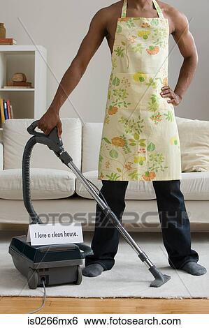 A man vacuum cleaning View Large Photo Image Stock Photograph - A man vacuum cleaning. Fotosearch