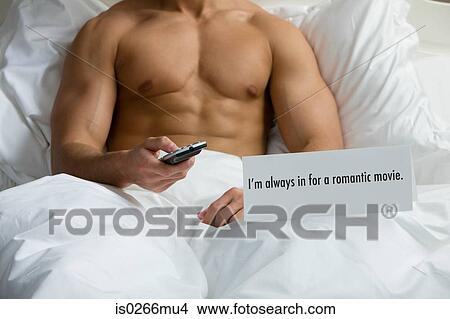 A man watching tv in bed View Large Photo Image Picture - A man watching tv in bed. Fotosearch