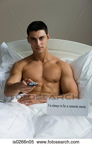 A man watching tv in bed View Large Photo Image Stock Photography - A man watching tv in bed. Fotosearch