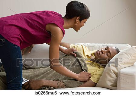 A woman covering a man with a blanket View Large Photo Image Stock Photograph - A woman covering a man with a blanket . Fotosearch