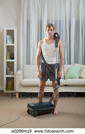 Portrait of a man with a vacuum cleaner View Large Photo Image Stock Photo - Portrait of a man with a vacuum cleaner. Fotosearch
