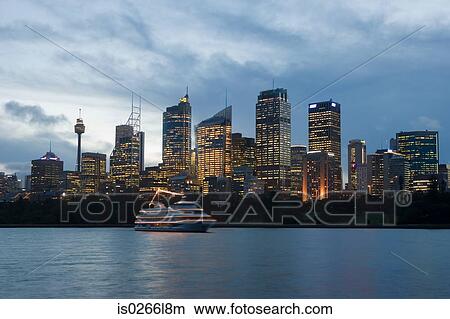 A boat and sydneys skyline at dusk View Large Photo Image Picture - A boat and sydneys skyline at dusk. Fotosearch