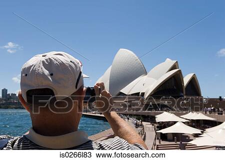 A tourist photographing sydney opera house View Large Photo Image Stock Image - A tourist photographing sydney opera house. Fotosearch