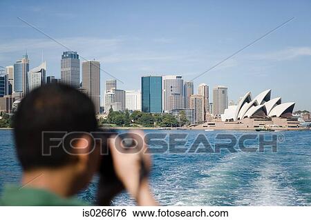 A tourist photographing sydney opera house View Large Photo Image Stock Photograph - A tourist photographing sydney opera house. Fotosearch