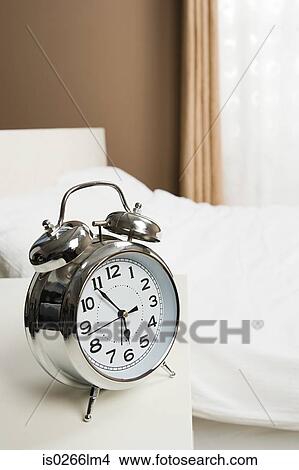 Picture - Alarm clock by bed. Fotosearch