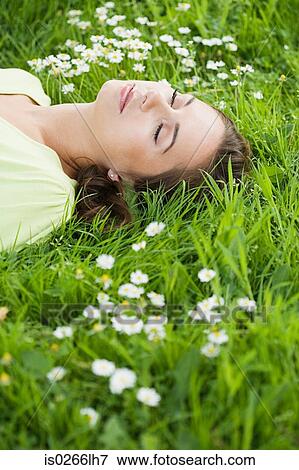 Stock Photo - Woman sleeping on grass. Fotosearch