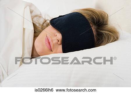 Woman sleeping with eye mask on View Large Photo Image Stock Photograph - Woman sleeping with eye mask on. Fotosearch