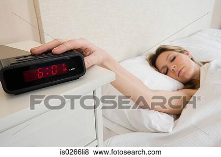 Woman with alarm clock View Large Photo Image Stock Photo - Woman with alarm clock. Fotosearch
