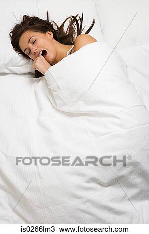Woman yawning in bed View Large Photo Image Stock Image - Woman yawning in bed. Fotosearch