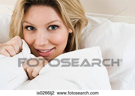 Young woman in bed View Large Photo Image Stock Image - Young woman in bed. Fotosearch