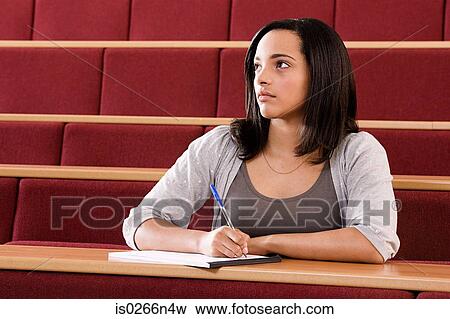 Stock Photo - Female student in lecture theatre. Fotosearch