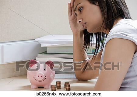 Stock Photo - Female student worrying about money. Fotosearch