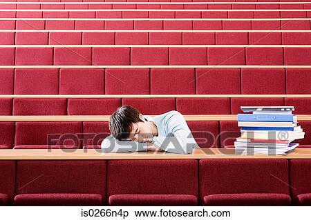 Stock Photography - Student sleeping in lecture theatre. Fotosearch