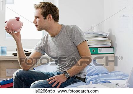 Stock Photography - Student with piggy bank. Fotosearch