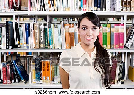 Young woman in library View Large Photo Image Picture - Young woman in library. Fotosearch