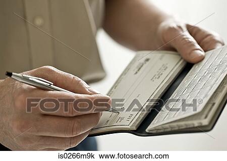 Stock Image - A man holding a cheque book. Fotosearch