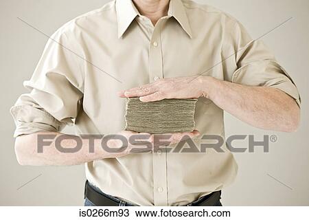 A person holding a pile of dollars View Large Photo Image Stock Image - A person holding a pile of dollars. Fotosearch