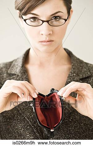A woman holding an empty purse View Large Photo Image Stock Image - A woman holding an empty purse. Fotosearch