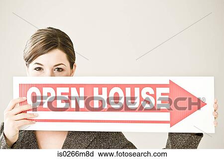 A woman holding an open house sign View Large Photo Image Stock Image - A woman holding an open house sign. Fotosearch
