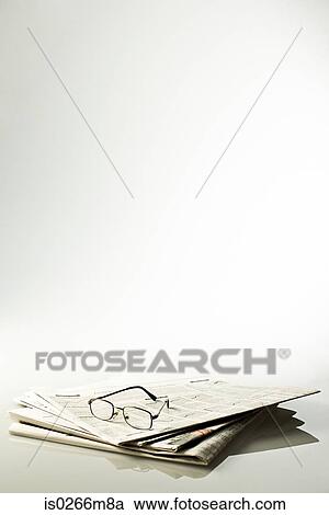 Stock Image - Glasses and newspapers. Fotosearch