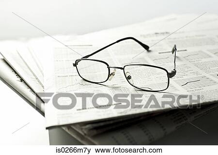 Stock Photo - Glasses and newspapers. Fotosearch