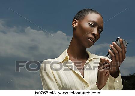 African businesswoman text messaging View Large Photo Image Stock Photo - African businesswoman text messaging. Fotosearch
