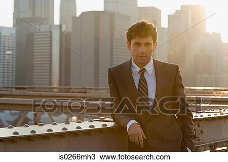 Businessman leaning on a girder View Large Photo Image Stock Image - Businessman leaning on a girder. Fotosearch