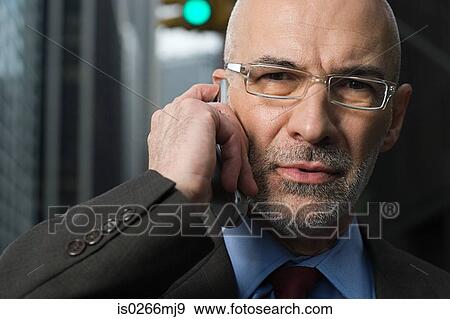 Businessman using a cellular telephone View Large Photo Image Stock Photo - Businessman using a cellular telephone. Fotosearch
