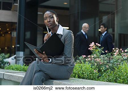 Businesswoman looking at a file View Large Photo Image Stock Image - Businesswoman looking at a file. Fotosearch