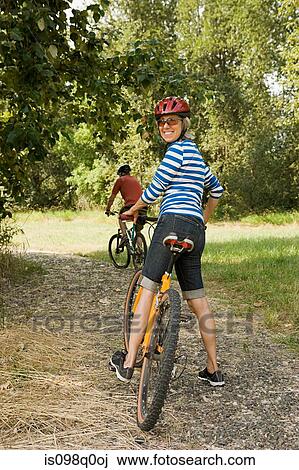 Stock Image - Couple cycling. Fotosearch