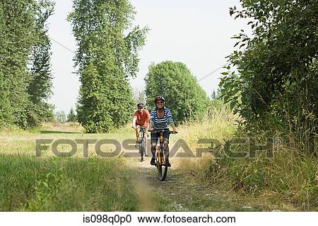 Couple cycling View Large Photo Image Stock Image - Couple cycling. Fotosearch